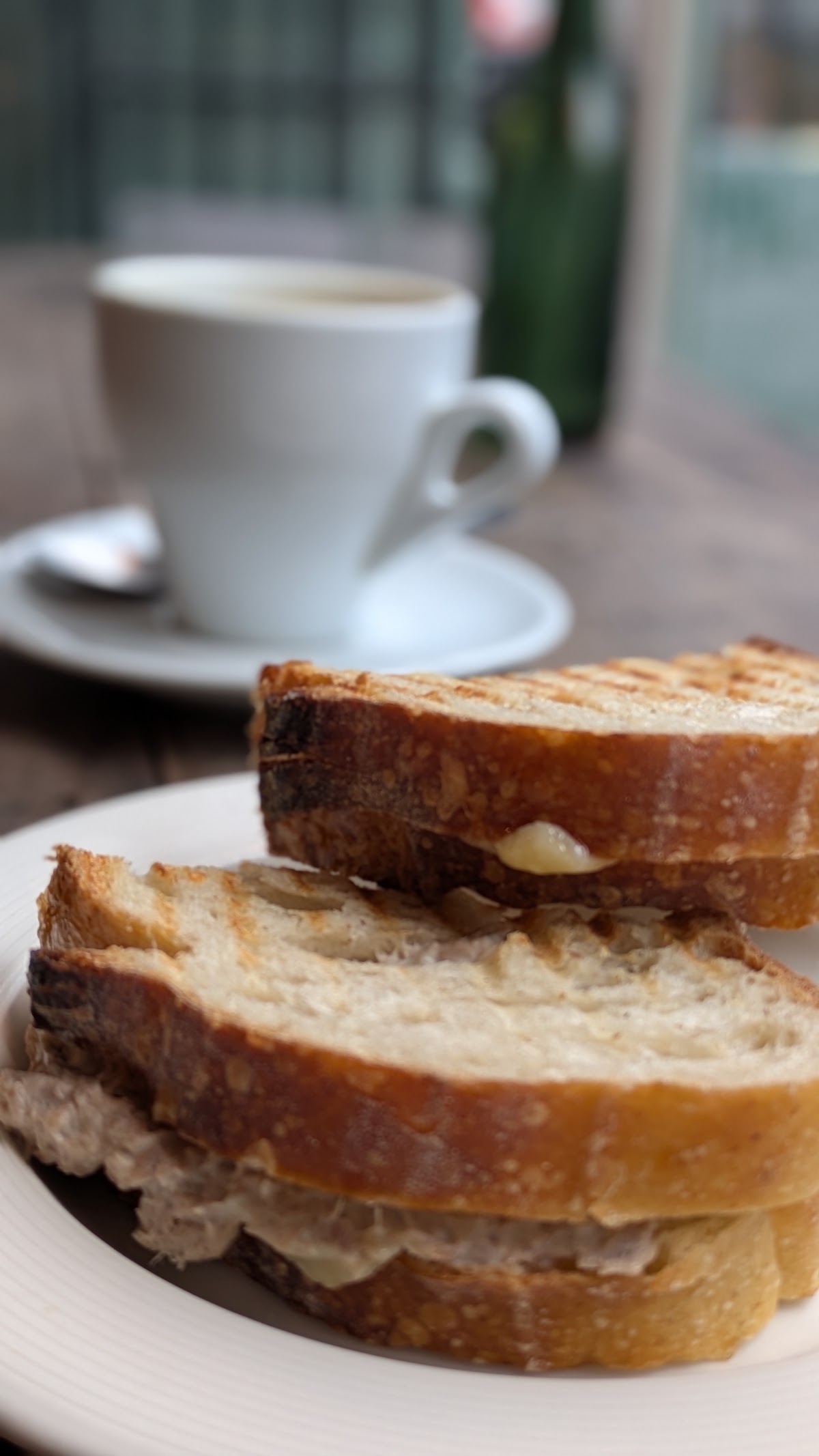 Toasted sourdough sandwich with a flat white